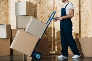 Man with a van Cootehill by Local Movers 30 delivery man carrying boxes on hand truck