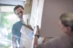 moving house couple lifting cardboard boxes 2025 04 04 19 56 36 utc
