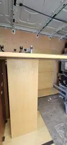 Inside a moving van, a wooden desk and shelving unit are being transported, showcasing professional commercial relocation by local movers.